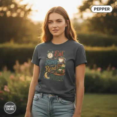 Pepper garment-dyed Comfort Colors t-shirt with Eat Sleep Read Repeat bold typographic print, worn outdoors by female model