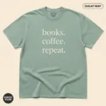 Chalky mint Comfort Colors garment-dyed tee with minimalist Books Coffee Repeat typographic print, studio frontal view