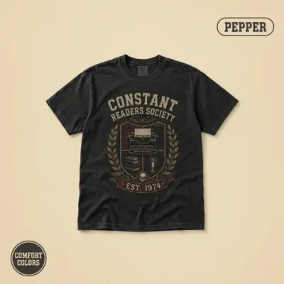 Pepper Comfort Colors t-shirt with vintage badge graphic reading Constant Readers Society Est 1974 – Stephen King horror book club design, front view