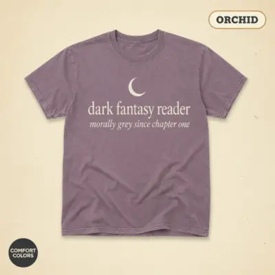 Dark fantasy reader garment-dyed t-shirt in orchid – Gothic linework illustration with stacked books and shadow creatures on Comfort Colors 1717 cotton