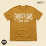 Enemies to lovers romance trope shirt on mustard garment-dyed Comfort Colors 1717 tee, front studio view