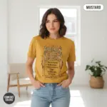 Mustard Comfort Colors garment-dyed tee with "Enemies to Lovers Is My Cardio" typographic print, worn by a young woman indoors