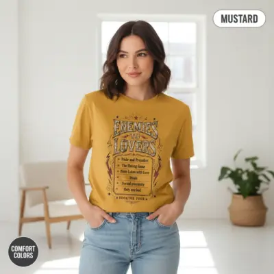 Mustard Comfort Colors garment-dyed tee with "Enemies to Lovers Is My Cardio" typographic print, worn by a young woman indoors