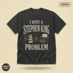 Pepper Comfort Colors garment-dyed tee with bold typographic "I Have a Stephen King Problem" statement print – front chest center, studio flatlay