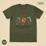 Jingle Books funny holiday book lover shirt in moss garment-dyed Comfort Colors 1717 – festive bookish pun typography graphic, studio frontal view
