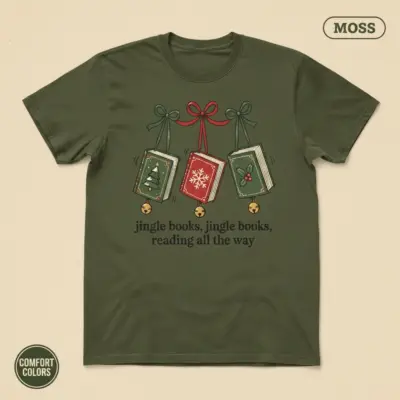 Jingle Books funny holiday book lover shirt in moss garment-dyed Comfort Colors 1717 – festive bookish pun typography graphic, studio frontal view