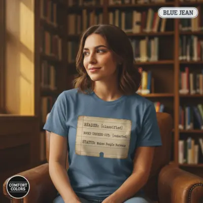 Woman wearing Blue Jean Comfort Colors garment-dyed tee printed with "My Reading List Makes People Nervous" banned books humor typography