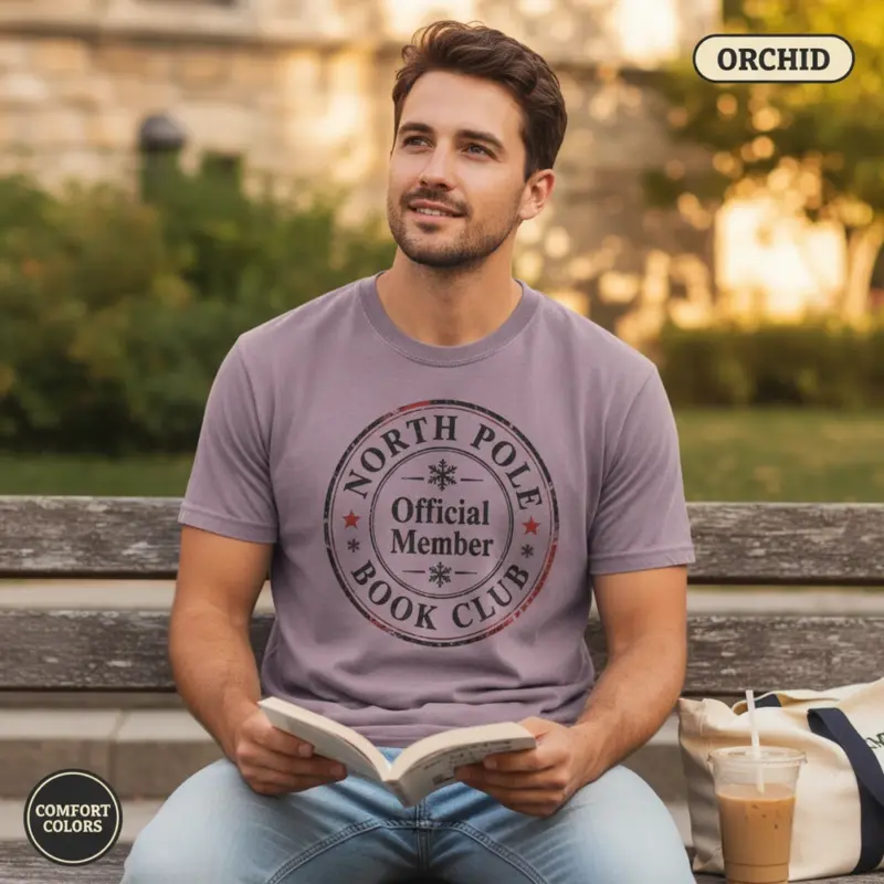 north pole book club christmas bookish gift garment dyed t shirt holiday reader tee outdoor reading male orchid