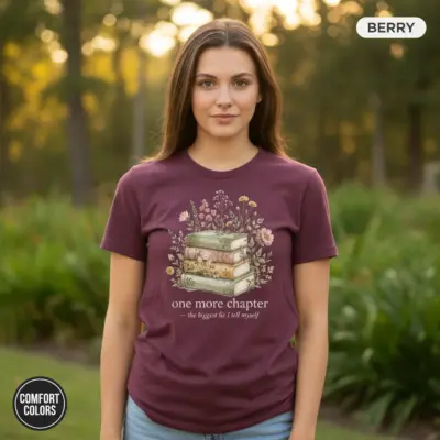 Berry Comfort Colors garment-dyed tee with "One More Chapter" distressed serif typography graphic, worn outdoors by female model