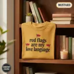 red flags are my love language funny dark romance garment dyed t shirt spicy bookish tee shelf vignette mustard