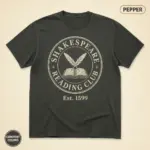 Pepper Comfort Colors garment-dyed t-shirt with vintage distressed Shakespeare Reading Club badge graphic, front view on studio background