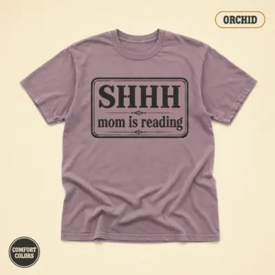 Orchid Comfort Colors garment-dyed t-shirt with bold Shhh Mom Is Reading typographic slogan – front studio view