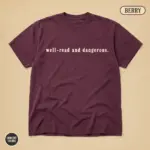 Berry Comfort Colors garment-dyed t-shirt with bold "Well-Read and Dangerous" banned books typographic statement – front view